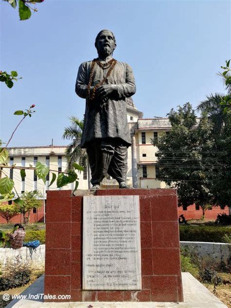 a statue of a man standing in front of a building