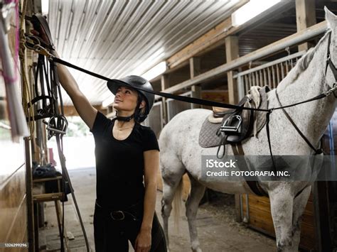 Young Female Trainer Prepping Her Horse Stock Photo - Download Image ...