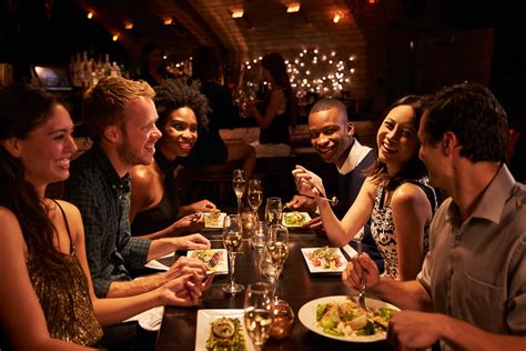 Group Of Friends Enjoying Meal In Restaurant • 7evendenhemel