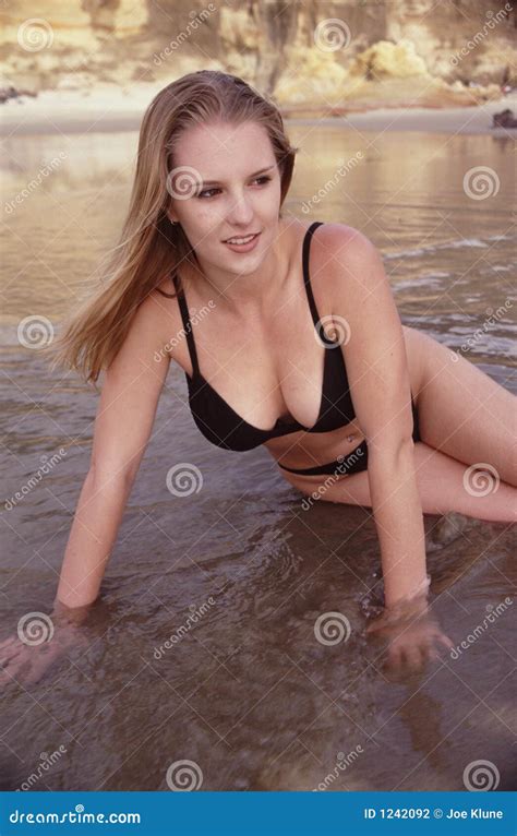 Bikini Model Posing On The Rocks Royalty Free Stock Photography