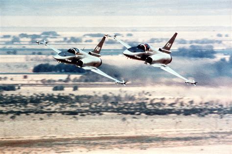 An air-to-air left front view of two Northrop F-20 Tigershark aircraft ...