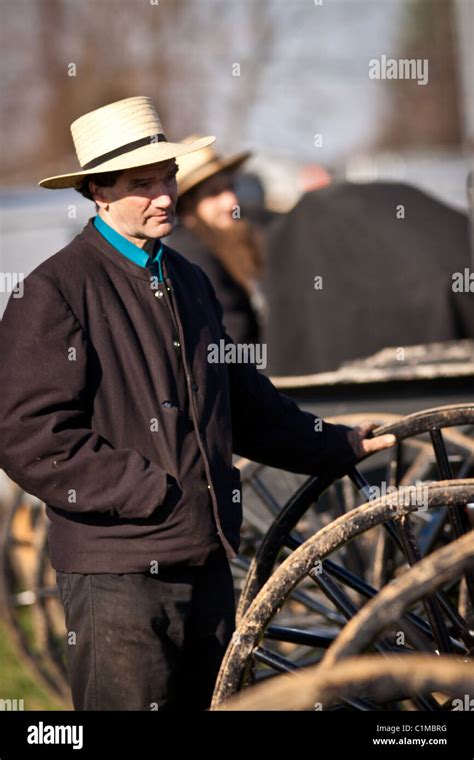 Amish Man Watches The Auction During The Annual Mud Sale To Support The