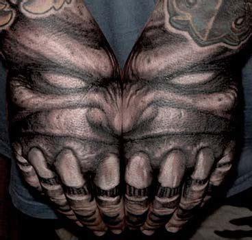 Demon with teeth hand tattoo by Paul Booth: TattooNOW