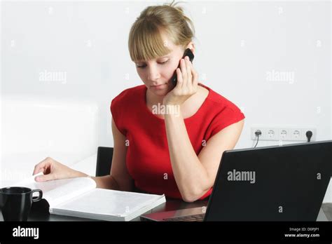 Businesswoman With Cellphone Reading Magazine Stock Photo Alamy