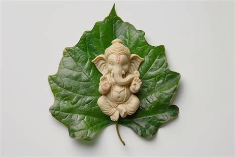 Baby Lord Ganesh Idol On Green Leaves Premium Ai Generated Image