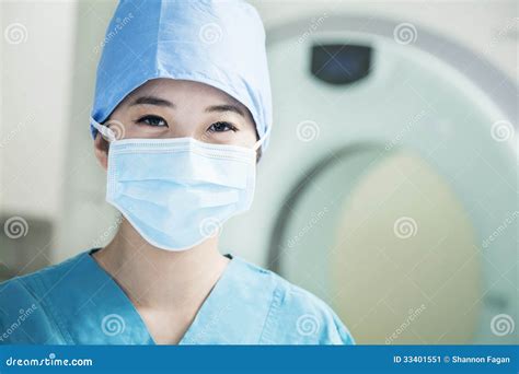 Portrait Of Young Female Surgeon Wearing Surgical Mask In The Operating