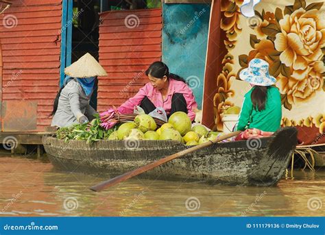 Women Buy And Sell Food From The Boat At The Floating Market At Tonle