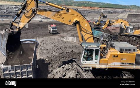 Excavators Working On Huge Mining Site Loading The Trucks Trucks