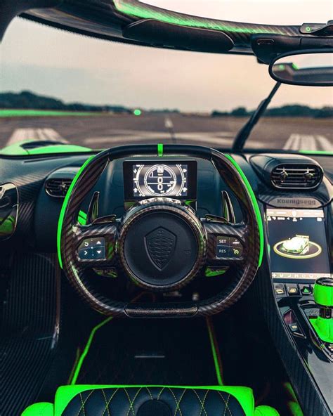 the interior of a sports car with neon green trims and leather steering ...