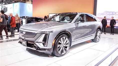 Crowds Looking at New Car Models at Auto Show. Cadillac Car on Display ...