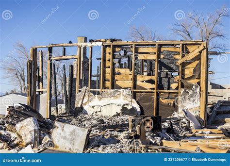 Charred Remains Of One Wall Left Standing After A House Fire Stock