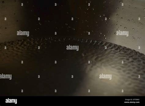 Tibetan singing bowl full of water close up water drops / sound healing ...