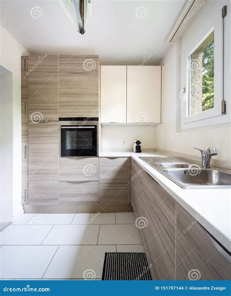 Modern Kitchen with Wood and a Window Where a Lot of Light Enters Stock