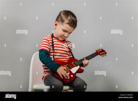 Child Playing Electric Guitar Portrait Of Young Boy Playing Children