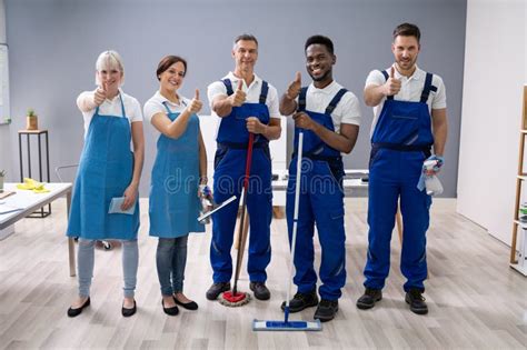 Janitors Showing Thumb Up Sign In The Office Stock Photo Image Of