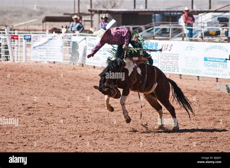 A Cowboy Competes In The Saddle Bronc Riding Event During The Oodham