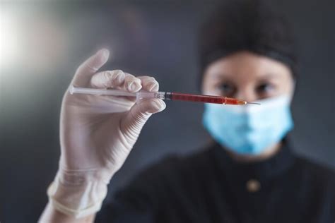 Premium Photo Woman Doctor In Black Uniform Mask And Gloves Holding