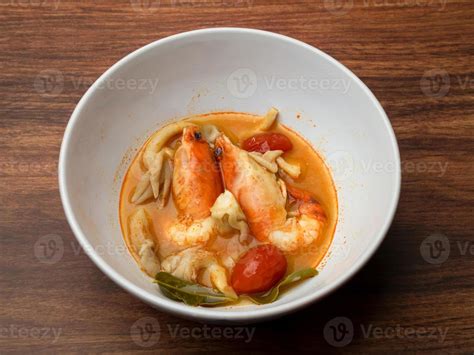 Hot And Spicy Shrimp Soup Or Thai Food Tom Yum Goong In White Bowl On Wooden Table Stock