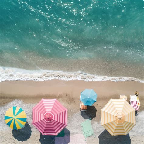 Aerial View Of A Sandy Beach With Colorful Umbrellas And Turquoise