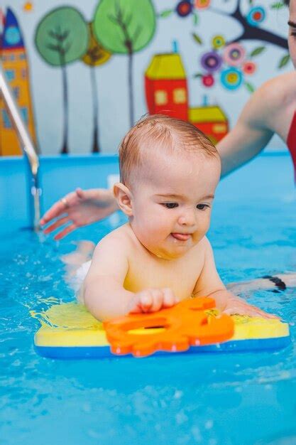 Um Menino Est Aprendendo A Nadar Em Uma Piscina Infantil