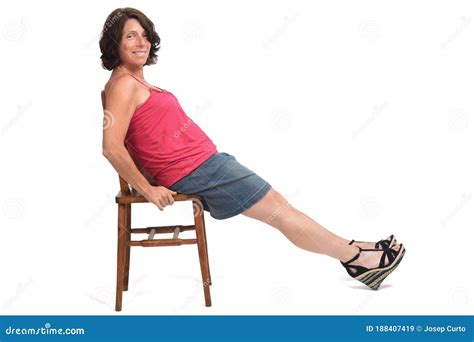 Woman Sitting On Chair With Skirt And Legs Stretched Out Stock Image