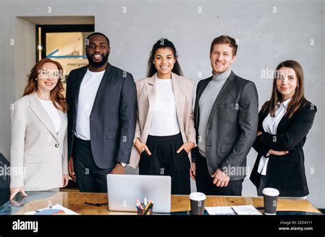 Portrait Of Successful Multiracial Business Team Standing In Modern