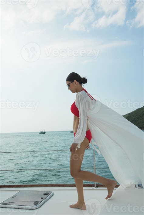 Beautiful Asian Mix Race Tanned Skin Woman Walk Along Luxury Yachts In Deep Ocean Red Bikini