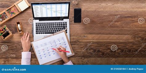 Businesswoman Scheduling The Plan Using Calendar And Laptop Stock Photo