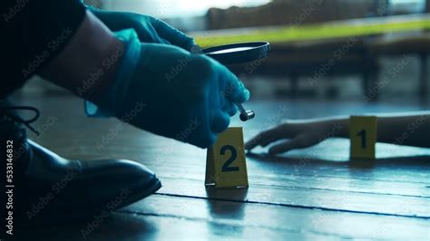 Detective Collecting Evidence In A Crime Scene Forensic Specialists