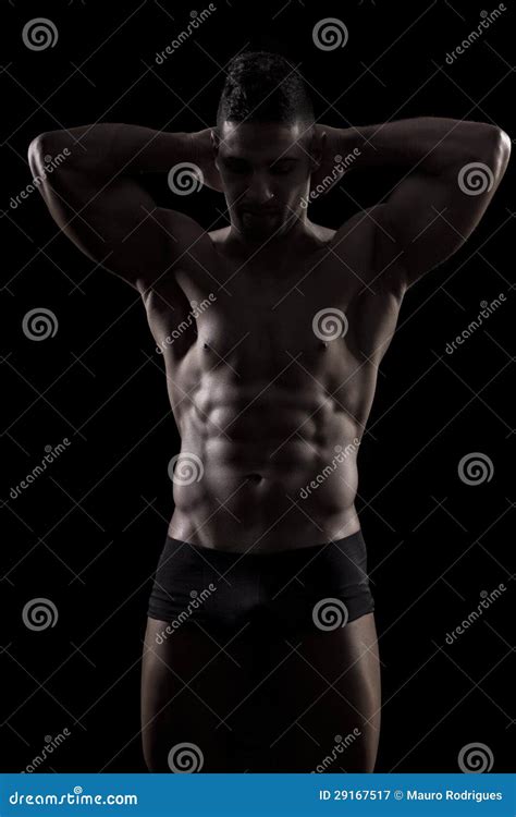 Homem Muscled Em Um Fundo Preto Imagem De Stock Imagem De Forte