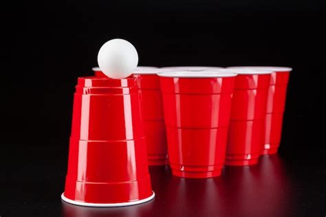 Premium Photo Red Plastic Cups And Ball For Game Of Beer Pong