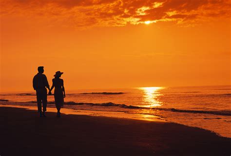 Two People Walking On The Beach In The Sunset - Viewing Gallery