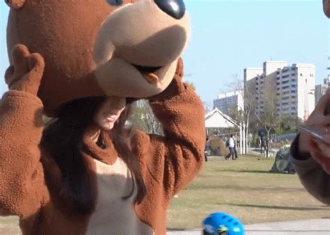 Woman In Brown Bear Costume With Friends