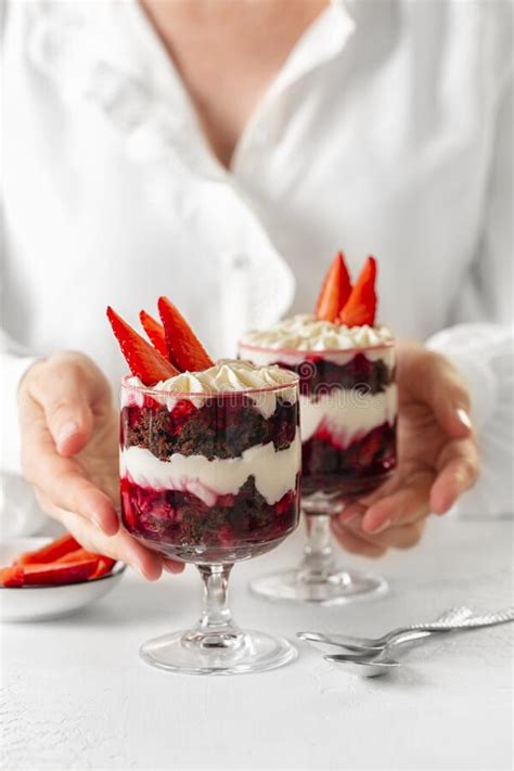 Woman Holding Chocolate Brownie Trifle with Cream Cheese and ...