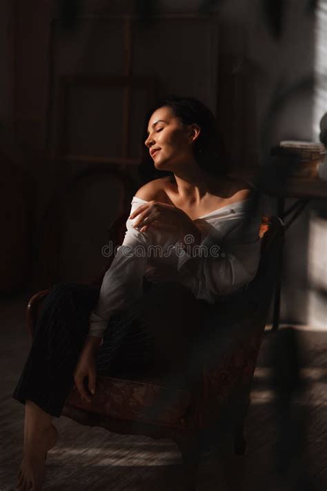 Attractive Relaxed Brunette Woman In A White Shirt With Bare Shoulders Stock Image Image Of