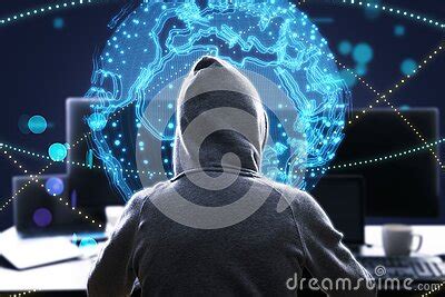 Back View Of Hacker At Desktop Using Laptop With Bright Globe Hologram