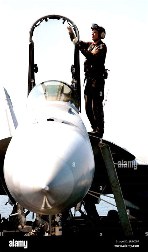 US Navy A Sailor Cleans The Canopy Of An F A 18C Hornet On The Flight