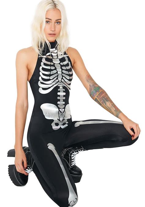 A Woman With White Hair Wearing A Skeleton Bodysuit And Holding A Pair Of Dumbbells