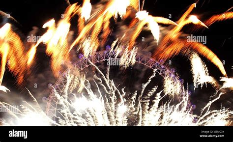 The London Eye is lit up by fireworks for London's New Year ...