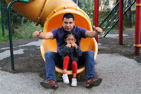 Dad With His Brunette Latina Daughter Play In The Park In The Games They Spend Quality Time In