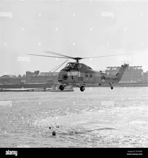 A Sikorsky S-58 helicopter takes up a person in the port of Den Helder ...