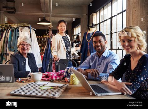 Portrait Of Four Fashion Designers In Meeting Stock Photo - Alamy