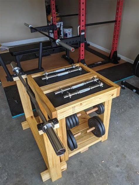 A Workbench Made Out Of Wood And Metal With Dumbbells On It