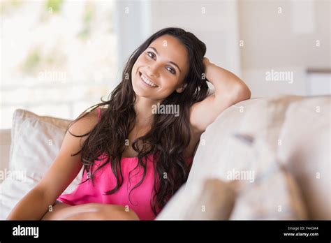 Pretty Brunette Relaxing On The Couch Stock Photo Alamy