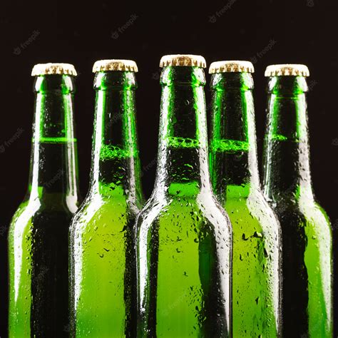 Premium Photo Glass Bottles Of Beer Are Arranged In The Center