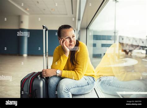 Pretty Young Brunette Woman Waiting For Delayed Flight At The Airport