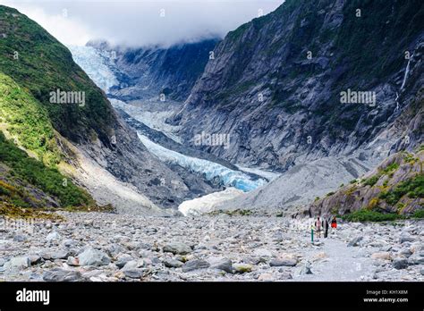 Tourists Hiking Up To The Franz Joseph Glacier South Island New