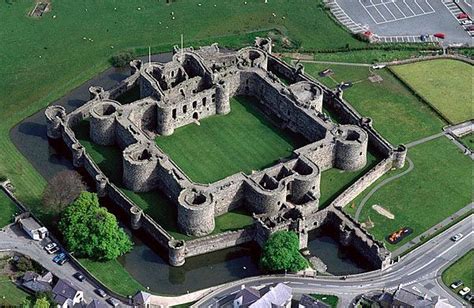 An Aerial View Of A Castle In The Middle Of A Town With Lots Of Green Grass