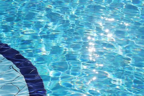 Clear Blue Water In Swimming Pool — Stock Photo © Brigidasoriano 22505879