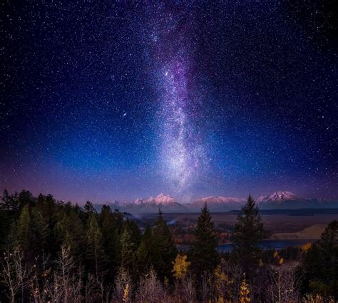 Landscape photo of white mountain ridge near body of water and green trees with and stargazing ...